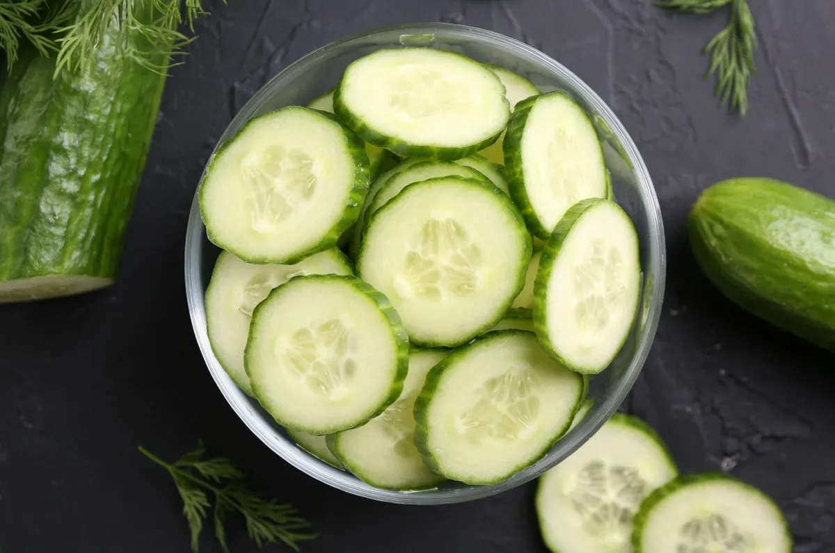 Cut,Cucumber,In,Glass,Bowl,,Fresh,Vegetables,And,Dill,On