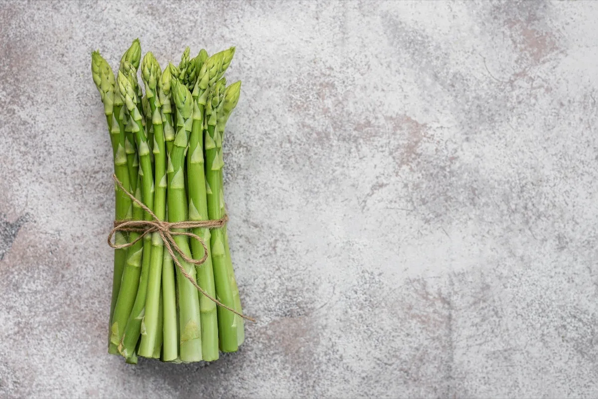 Fresh,Green,Asparagus,On,Grey,Concrete,Background.,Flat,Lay