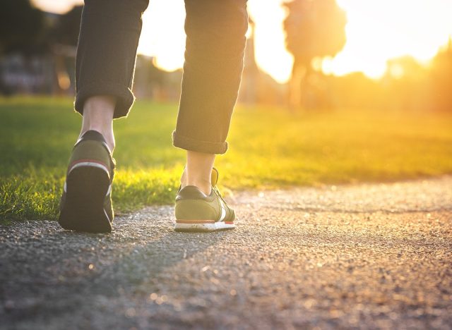 Woman,Walking,In,The,Park,,Outdoors.,exercise
