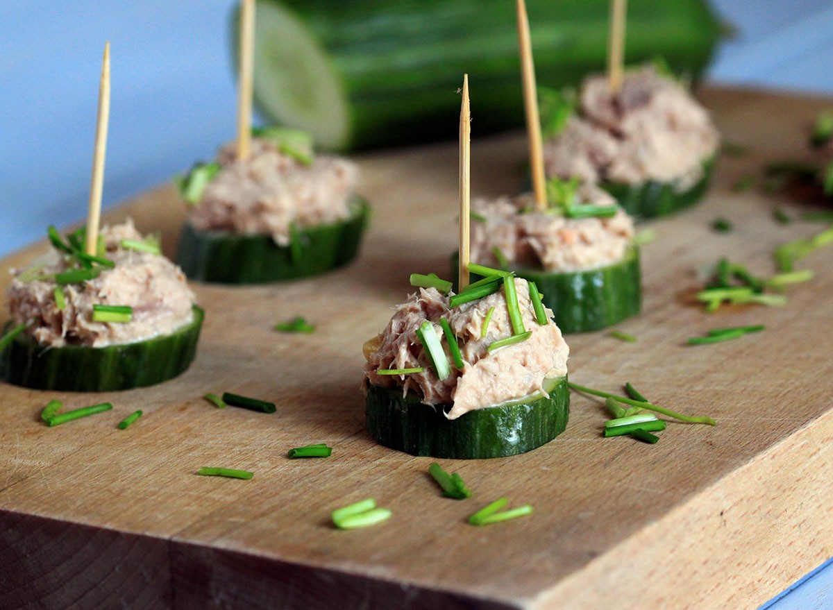 A tasty snack with cucumber and tuna. Party appetizer. Small sandwiches with cucumber and tuna paste.