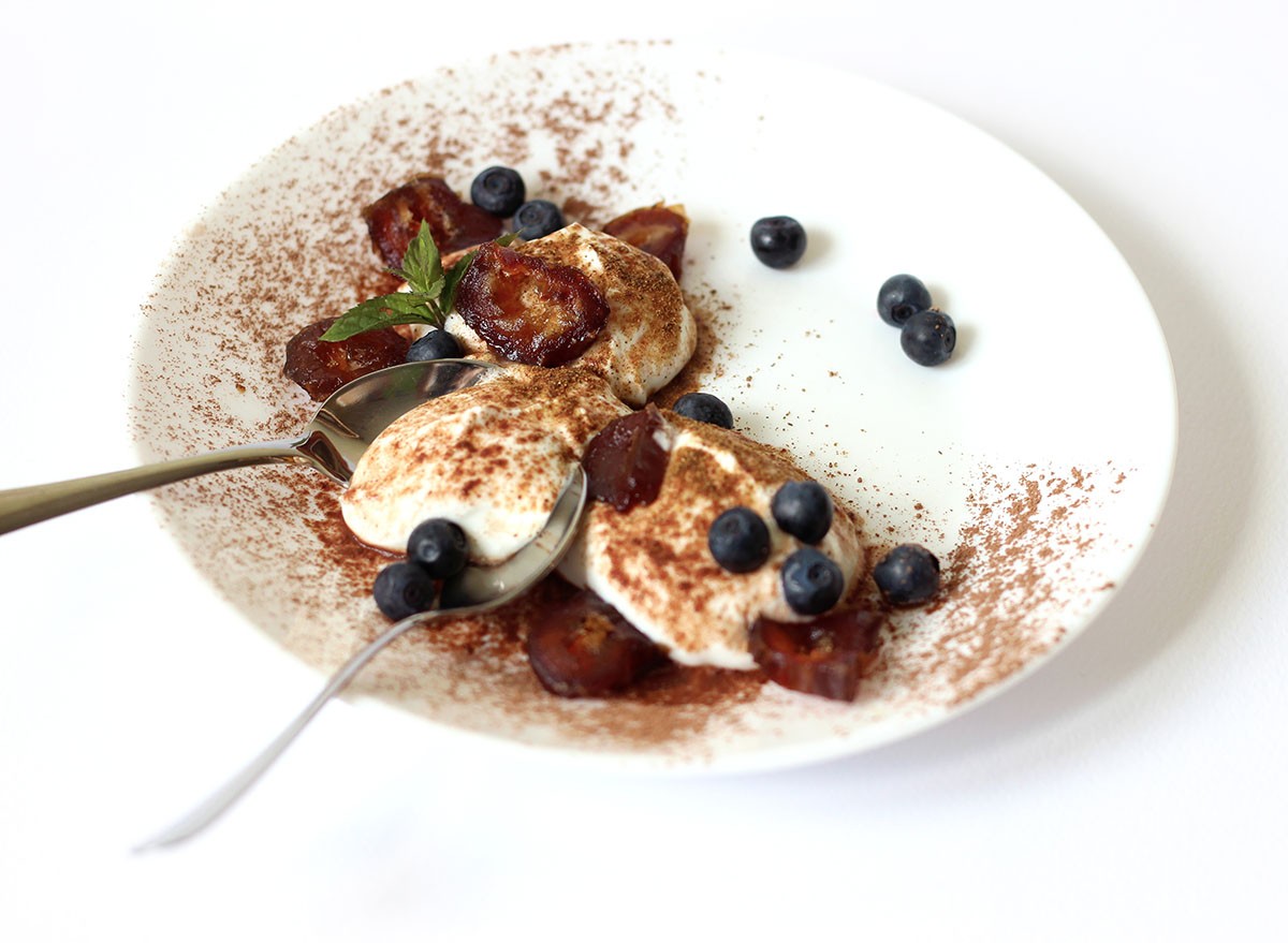 Plate of Greek Yogurt with Cocoa, Dates, and Blueberries. Healthy Breakfast Concept.