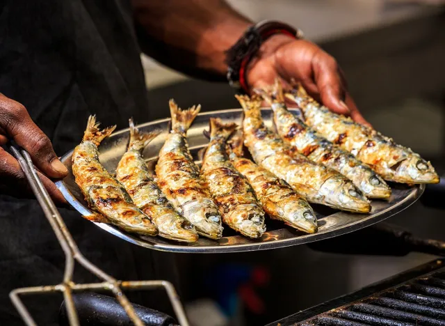 Freshly grilled sardines on a silver plate