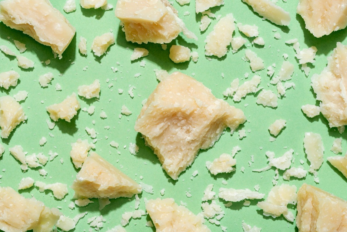 Parmesan,Pieces,On,A,Green,Table,,View,From,Above.,Background