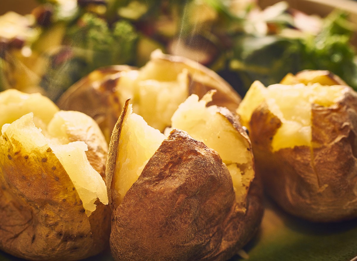 Hot buttered jacket baked potatoes close up with steam. baked potatoe
