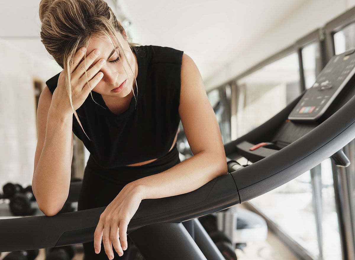 Dehydration, tired, Exhausted athletic woman after her fitness workout in the gym