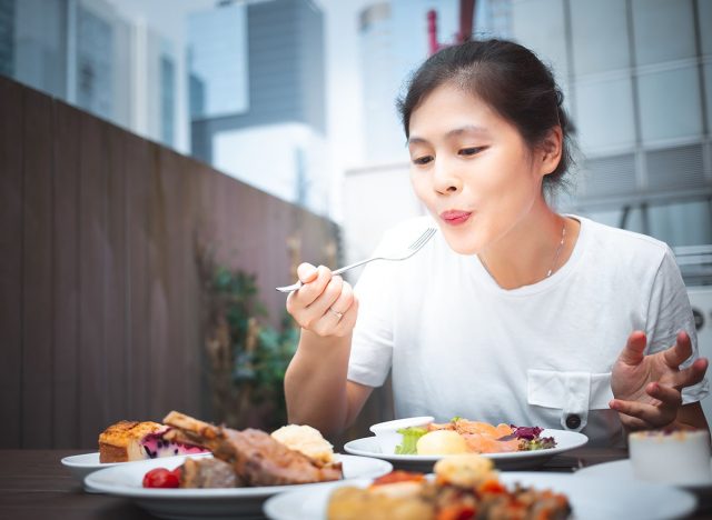 woman eating lunch outdoor, fork, dinner, restaurant
