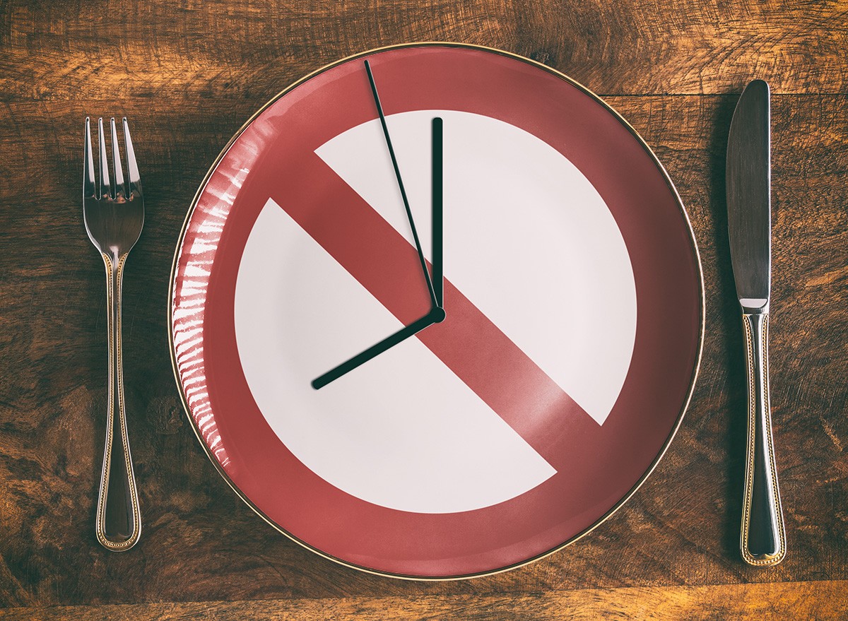 Skip breakfast concept with no symbol and clock on plate, Intermittent Fasting