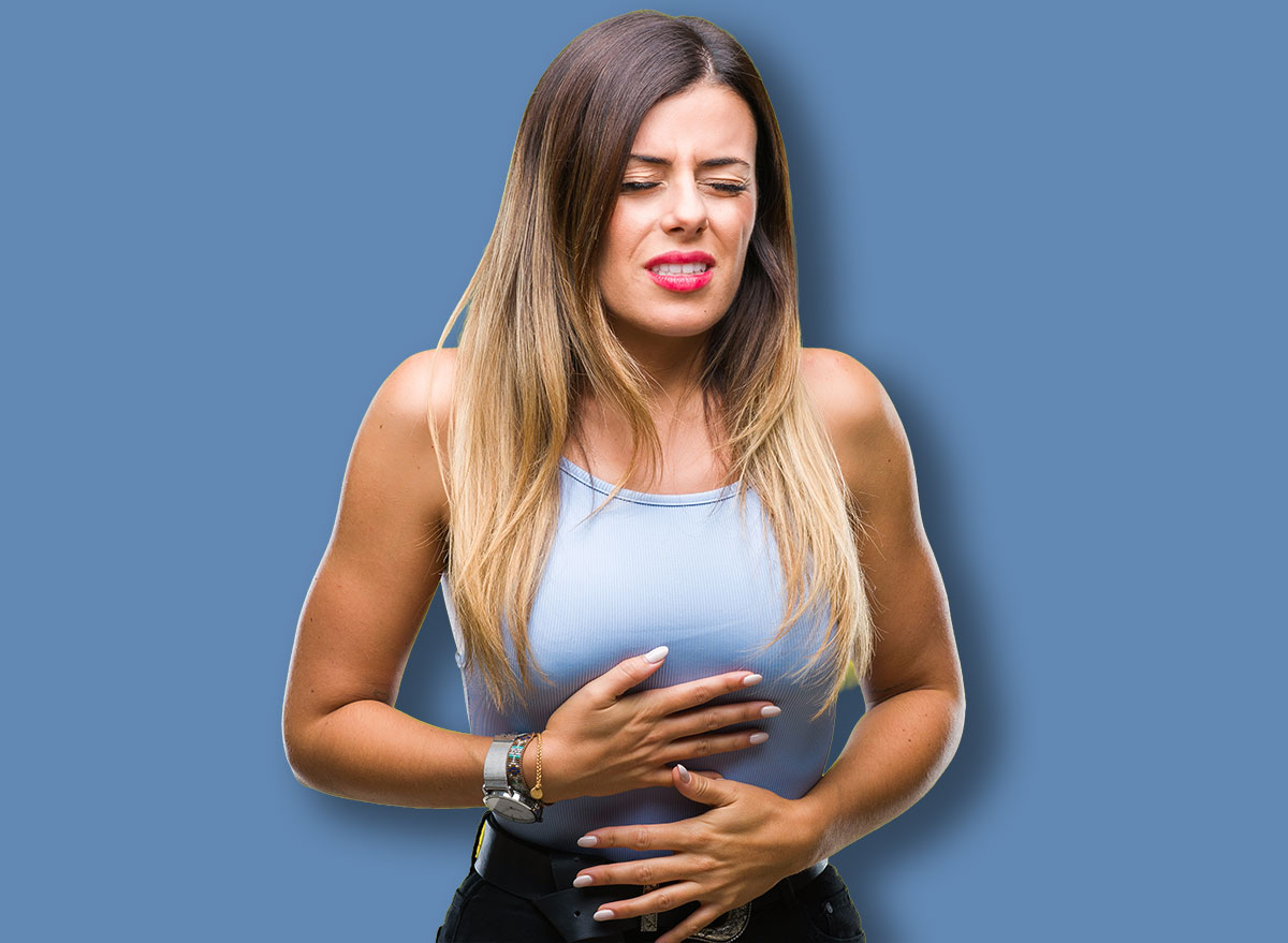 Young beautiful elegant business woman over isolated background with hand on stomach because indigestion, painful illness feeling unwell. Ache concept.