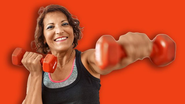 Middle age hispanic sporty woman smiling happy training using dumbbells at sport center.