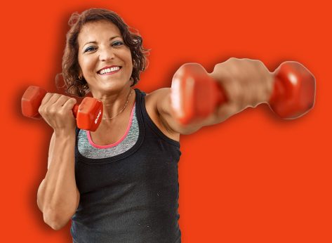 Middle age hispanic sporty woman smiling happy training using dumbbells at sport center.