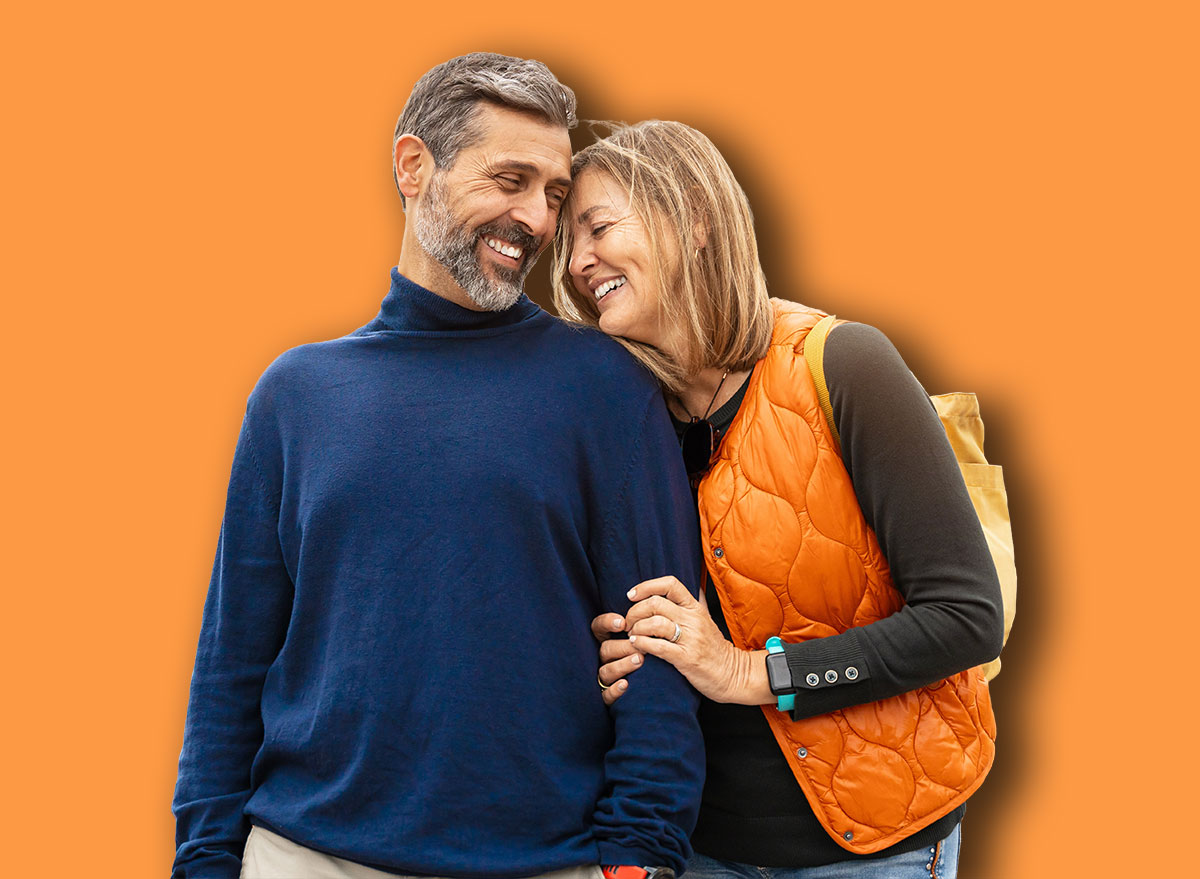 Romantic portrait of adult couple bonding with love in the city