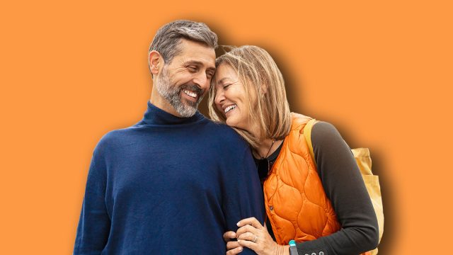 Romantic portrait of adult couple bonding with love in the city