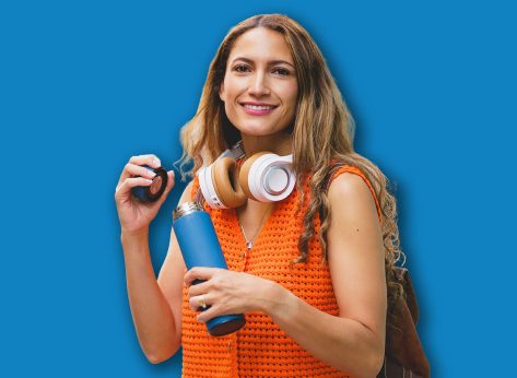 Portrait of a modern beauty latin woman drinking water using reusable bottle in the city