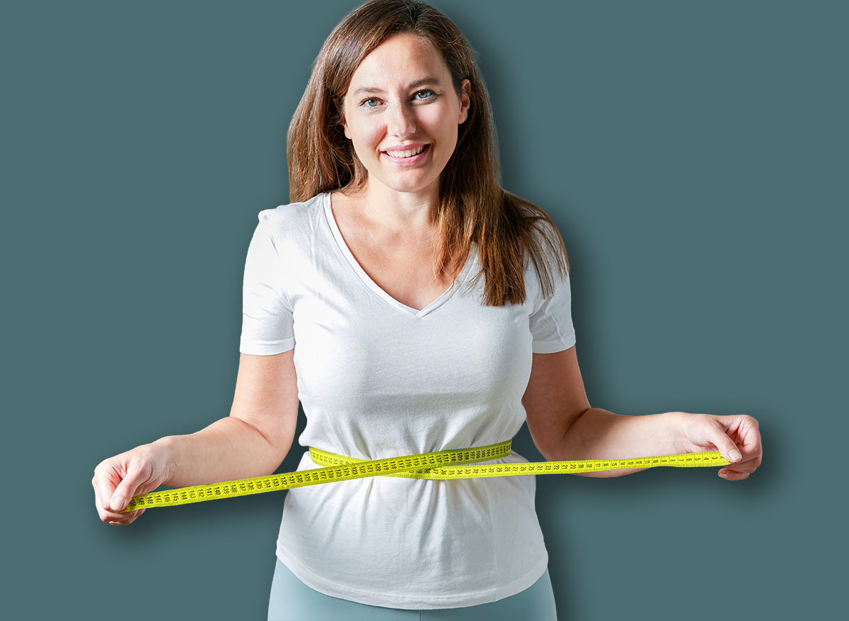 Woman with measuring tape around her waist.