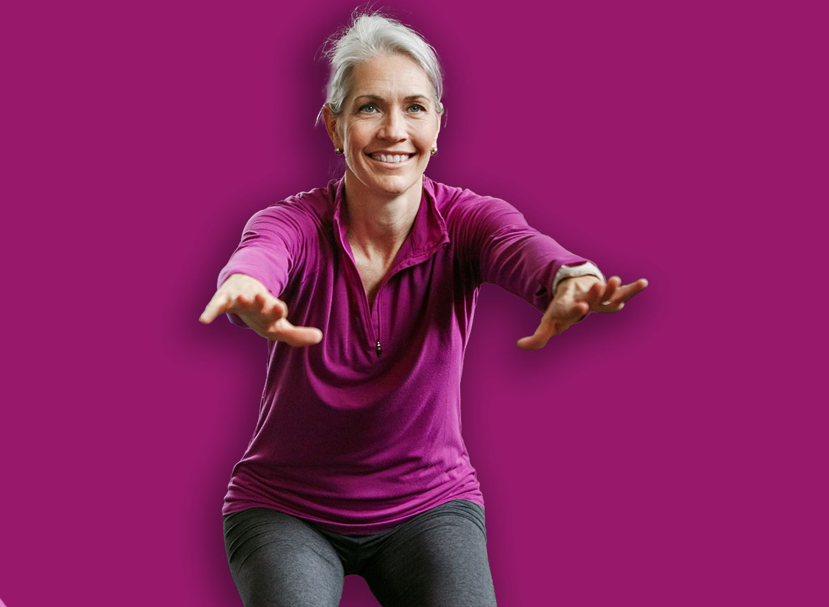 Mature group, woman and squat for exercise in gym, balance or coach for muscle development in class. Senior people, men and fitness for legs, smile or workout together in retirement at wellness club