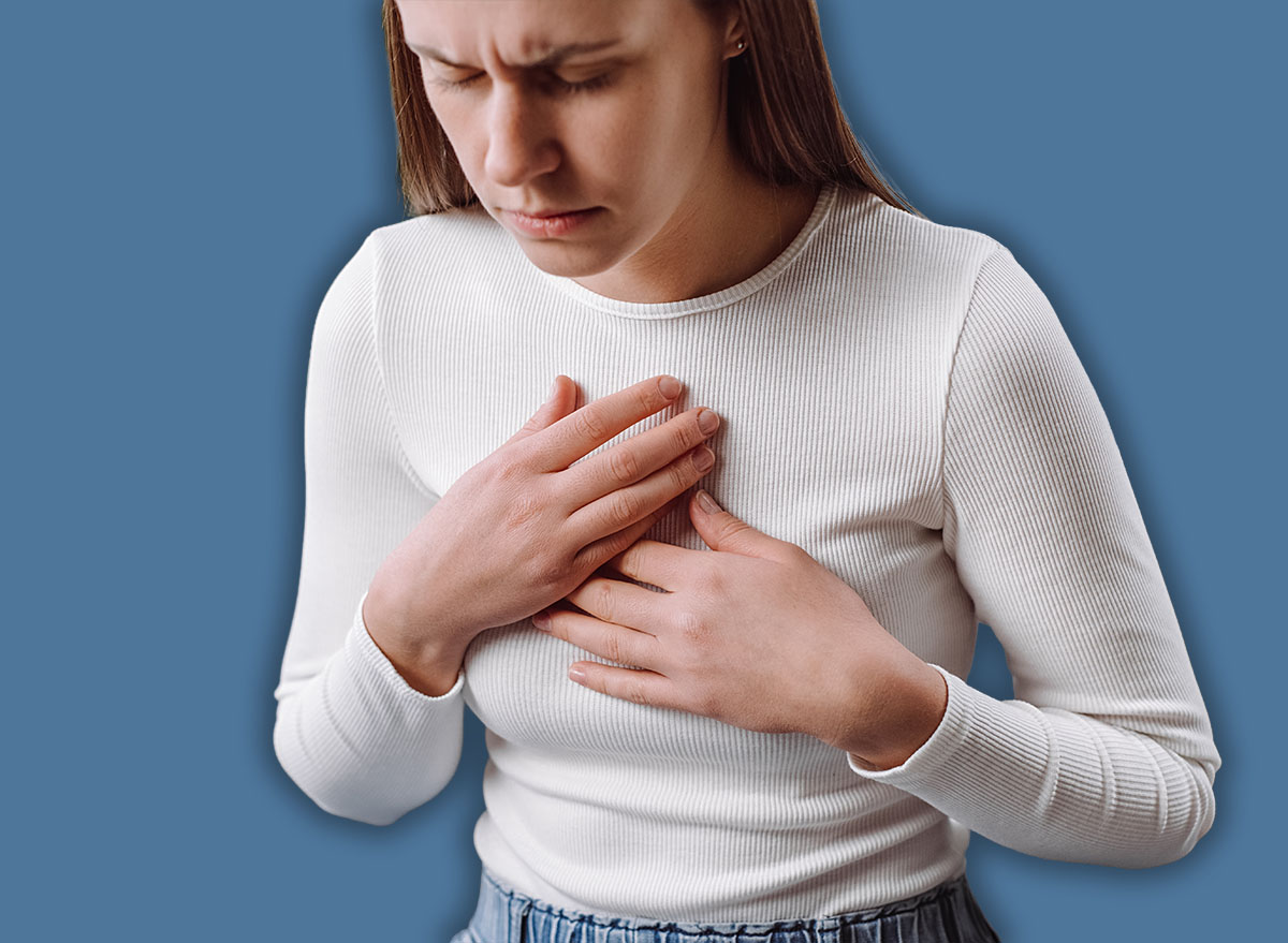 Acid reflux disease. Young woman sit on sofa have symptom gastroesophageal, esophageal, stomach ache and heartburn pain hand on chest from digestion problem after eat food. Healthcare medical concept