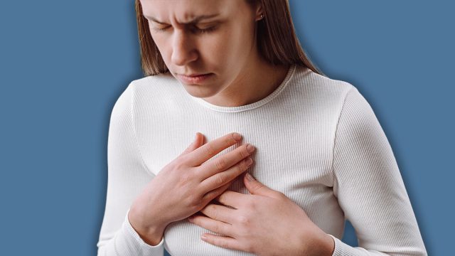 Acid reflux disease. Young woman sit on sofa have symptom gastroesophageal, esophageal, stomach ache and heartburn pain hand on chest from digestion problem after eat food. Healthcare medical concept