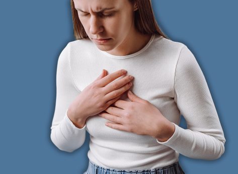 Acid reflux disease. Young woman sit on sofa have symptom gastroesophageal, esophageal, stomach ache and heartburn pain hand on chest from digestion problem after eat food. Healthcare medical concept