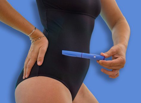Woman in a black swimsuit holding a blue injector pen Ozempic by the pool, managing her health on vacation concept of healthcare, pharmaceuticals, wellness. High quality photo