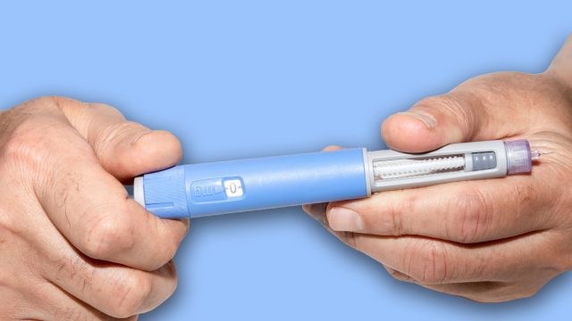 Ozempic Insulin injection pen or insulin cartridge pen for diabetics. Man holding an injection pen for diabetic. Medical equipment for diabetes parients.