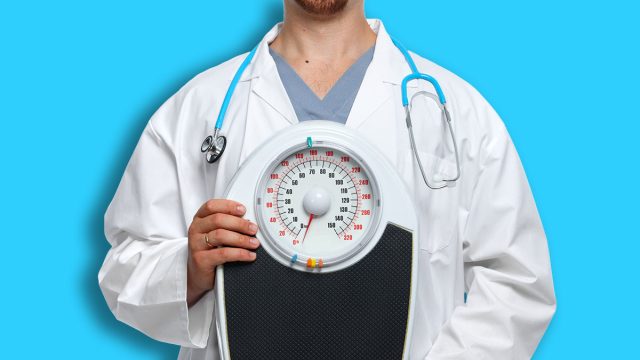 Medical doctor nutritionist with body scales. Weight loss.