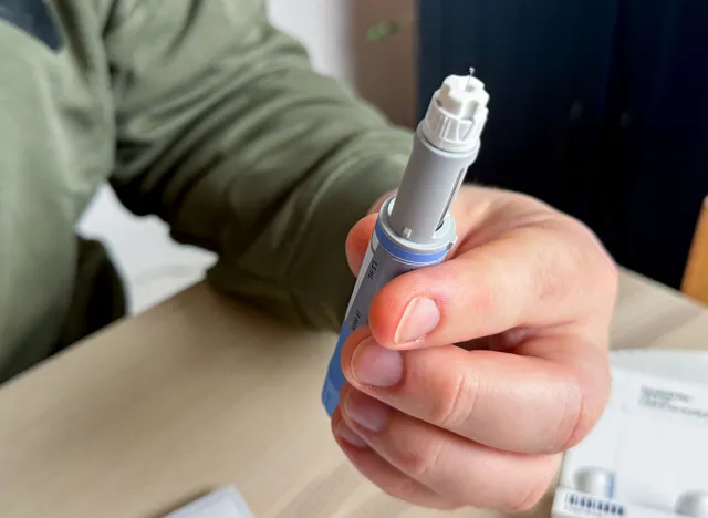 A hand of a Caucasian male gripping a sleek injection pen, symbolizing the empowerment of health rituals and digital detox holidays, Ozempic, GLP 1, Semaglutide, January 5 2026, Subotica, Serbia