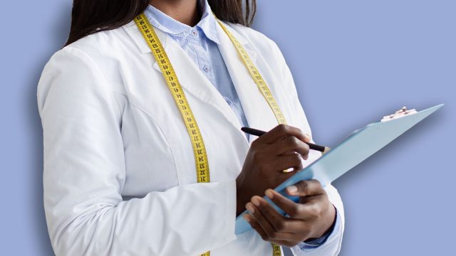 Cheerful black nutritionist with clipboard prescribing healthy diet or creating plant based meal plan for patient at weight loss clinic, copy space