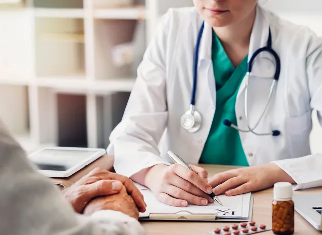 Doctor giving prescription to patient