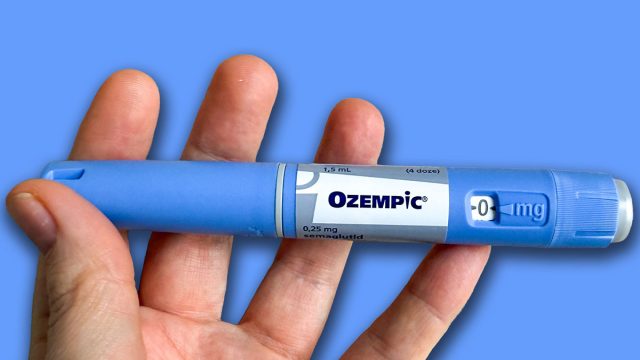 A hand cradles a mysterious blue pen, evoking whispers of medical alchemy and wellness resolutions, World Health Day; Ozempic, GLP 1, Semaglutide, January 5 2026, Subotica, Serbia