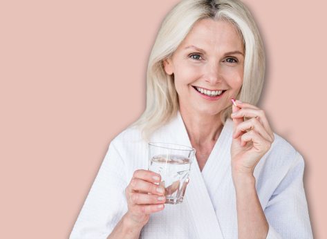 Web banner view of happy mature woman holding glass of still water, and vitamin pill with calcium and collagen. Mid age female feel good, smiling nice, taking dose of daily multivitamins at home