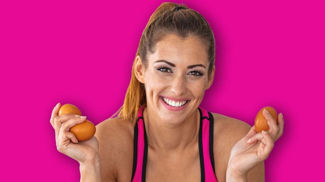 Young beautiful woman holding fresh egg at home with surprise face. Woman taking eggs. Beautiful young woman showing egg with happy face. Healthy homemade oatmeal